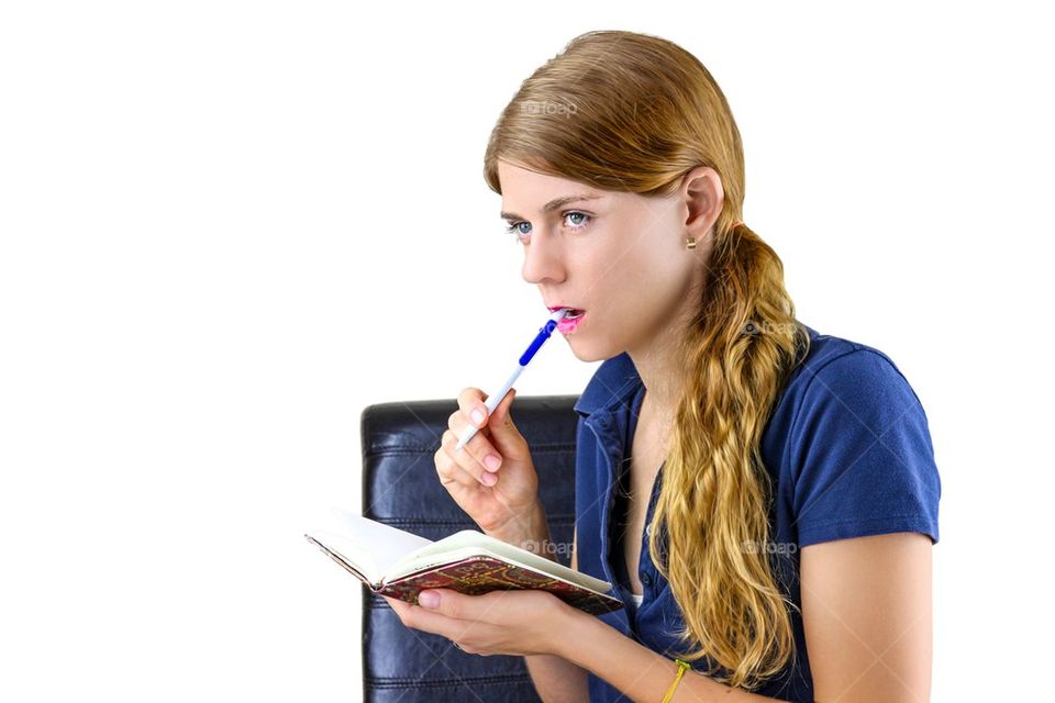 Woman thinking while writing