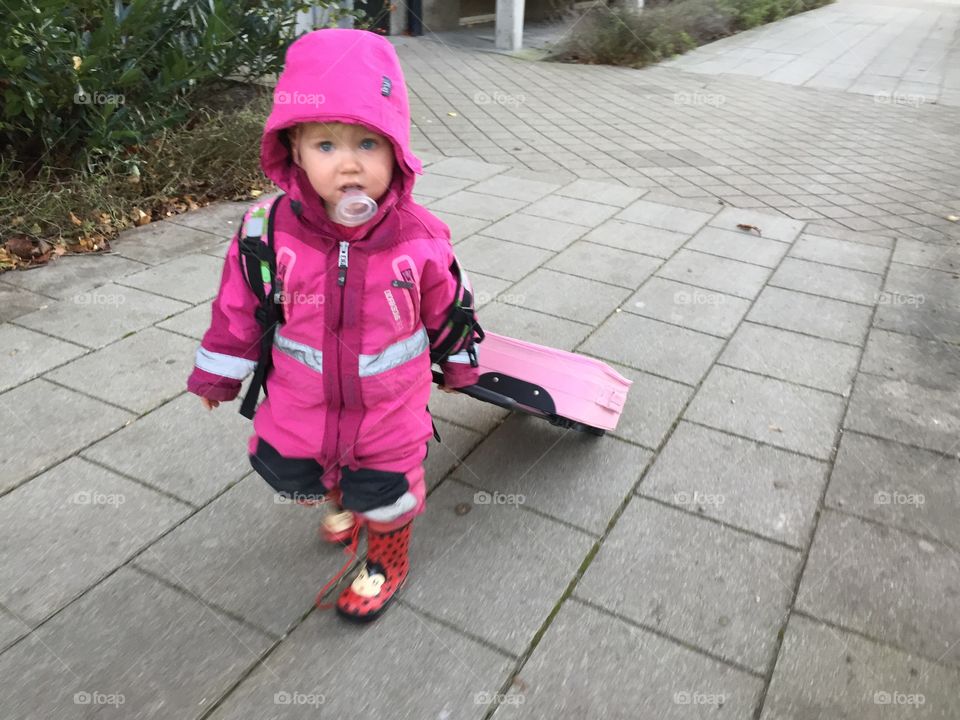 Little girl of two years old going on a trip with her own suitecase Malmö Sweden.