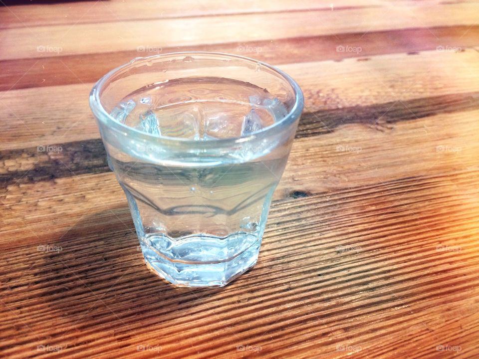 Glass with water on wood table