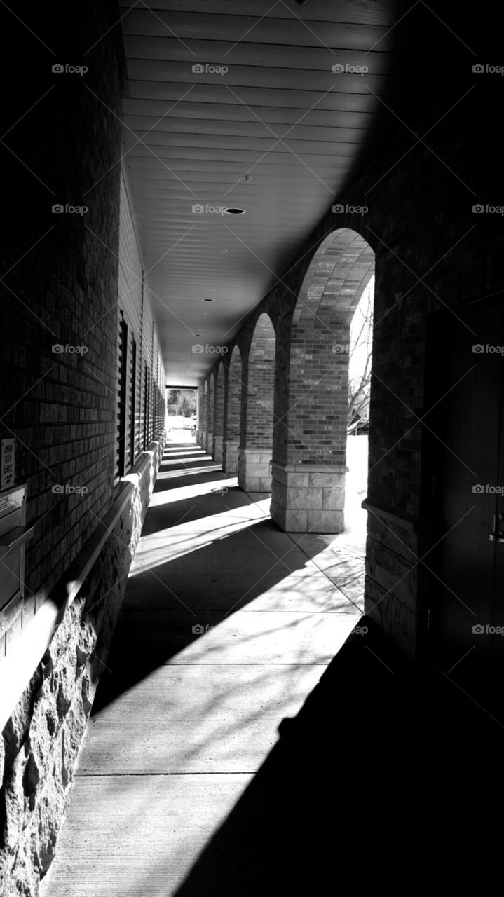 sunlit walkway in black and white