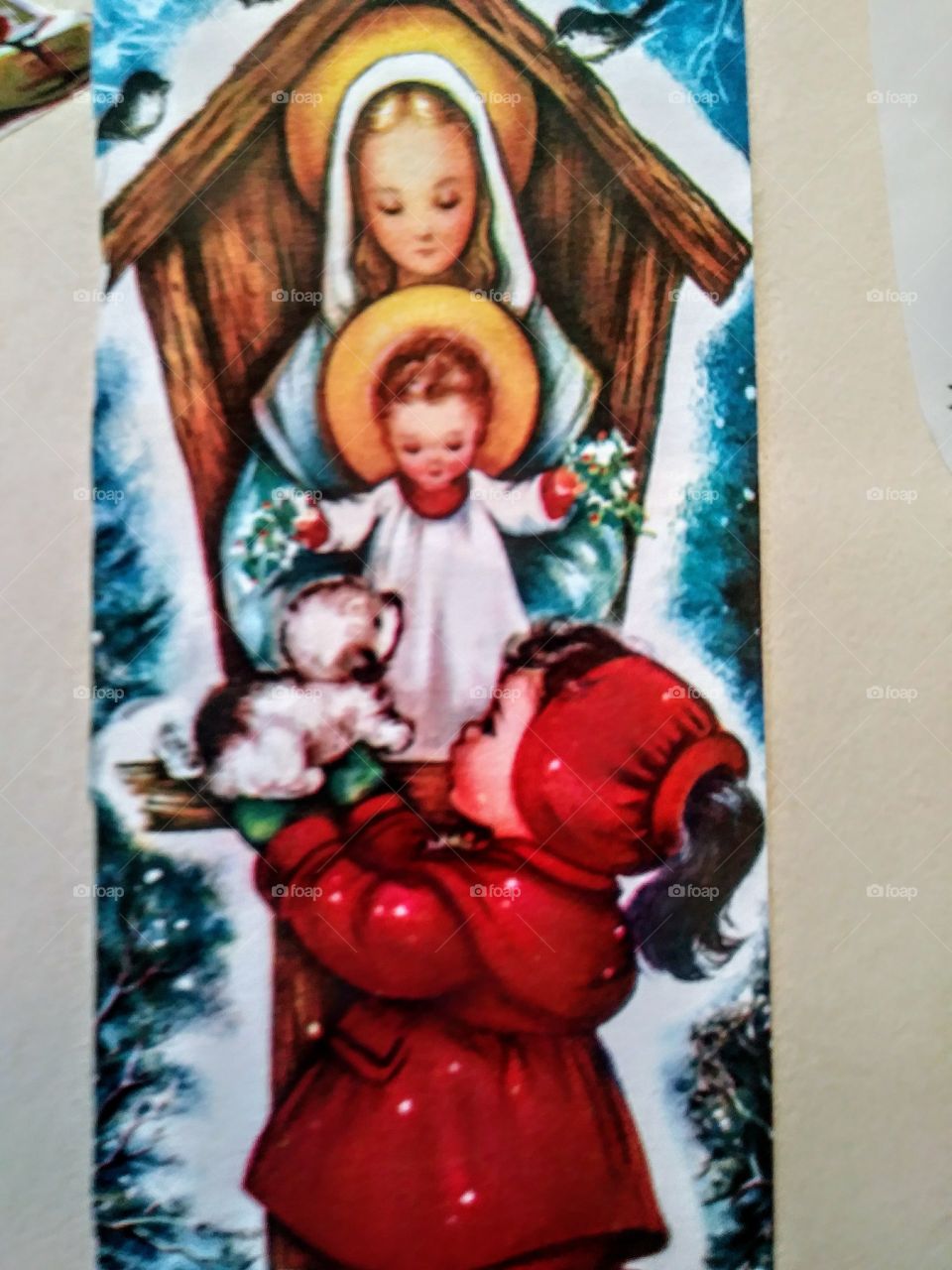 front of 1950s christmas card. mary and jesus with little girl giving jesus a puppy