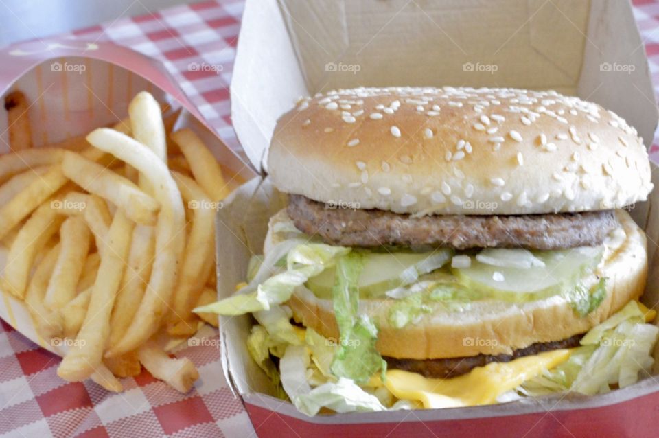 McDonald’s Big Mac, fries and drink on a red a white checkered background 