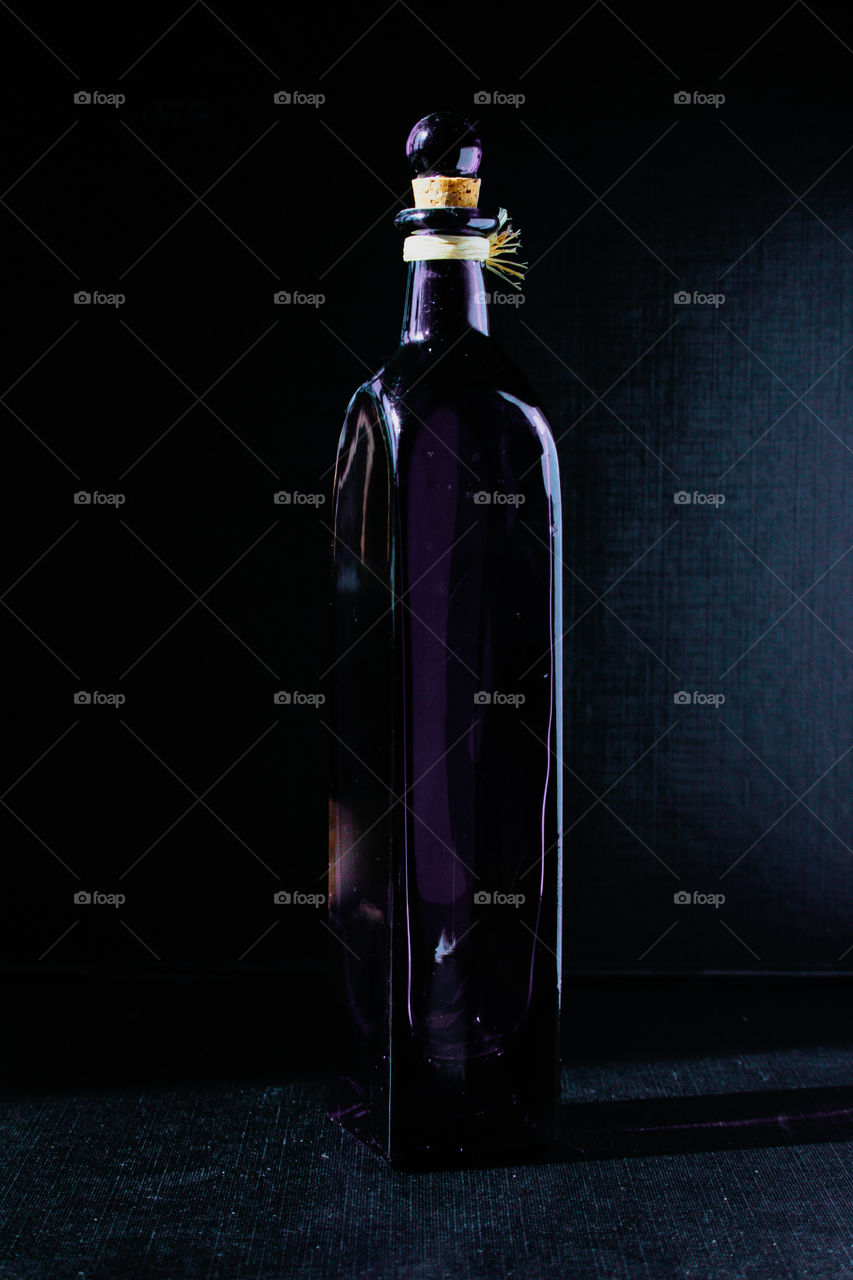 Blue bottle in black background 