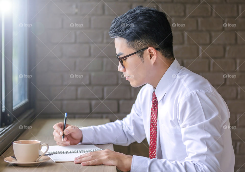 Businessman writing in diary