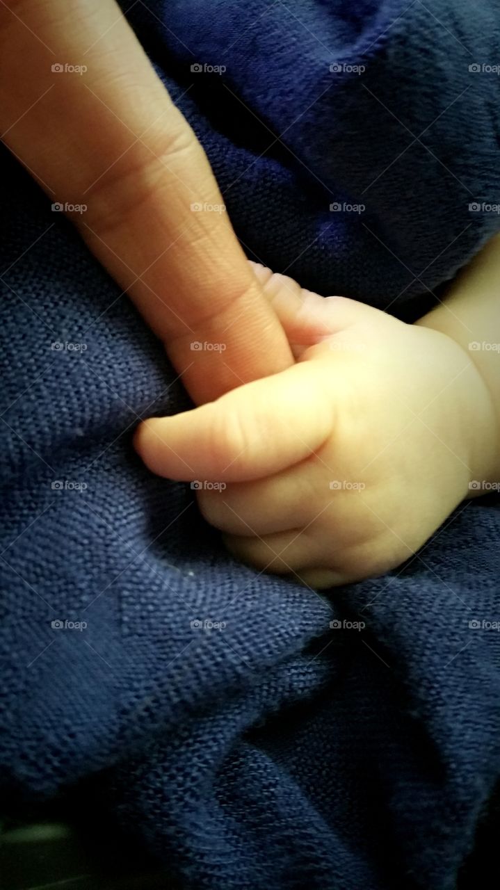 Baby Cecile has a grasp on my finger