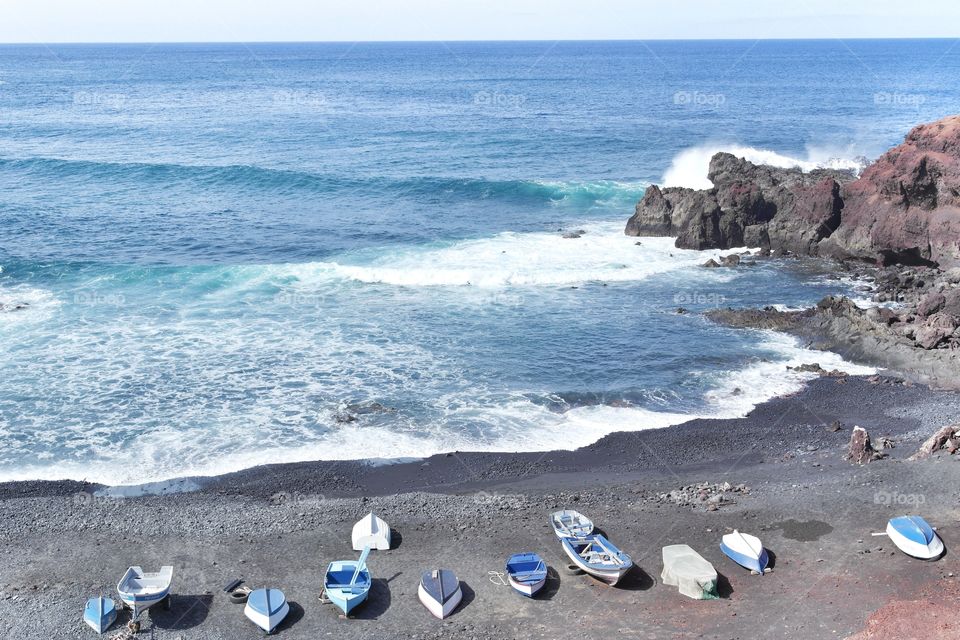 High angle view of seascape and boats on shore