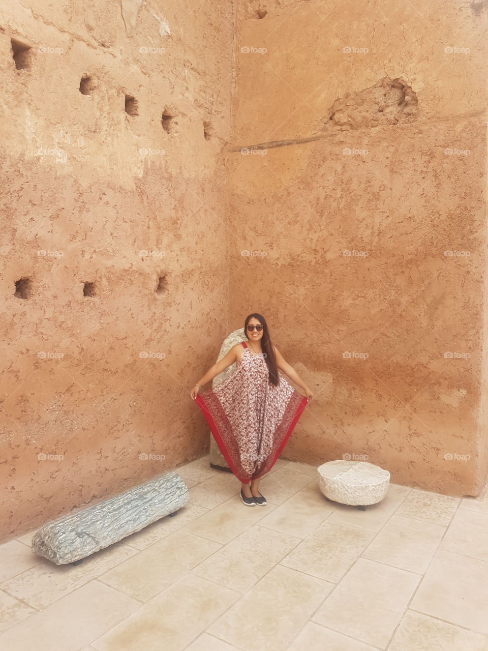 woman with asian costume in ancient monumental building made of mud