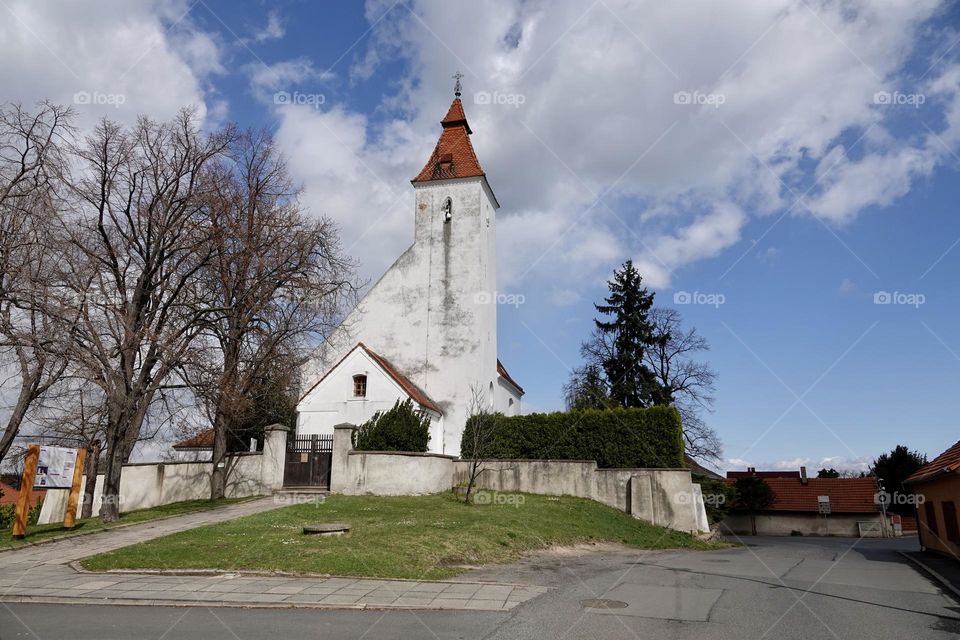 Church of the Nativity of St. John the Baptist, built in Romanesque style with a Baroque extension. In the village of Hovorcovice near Prague.