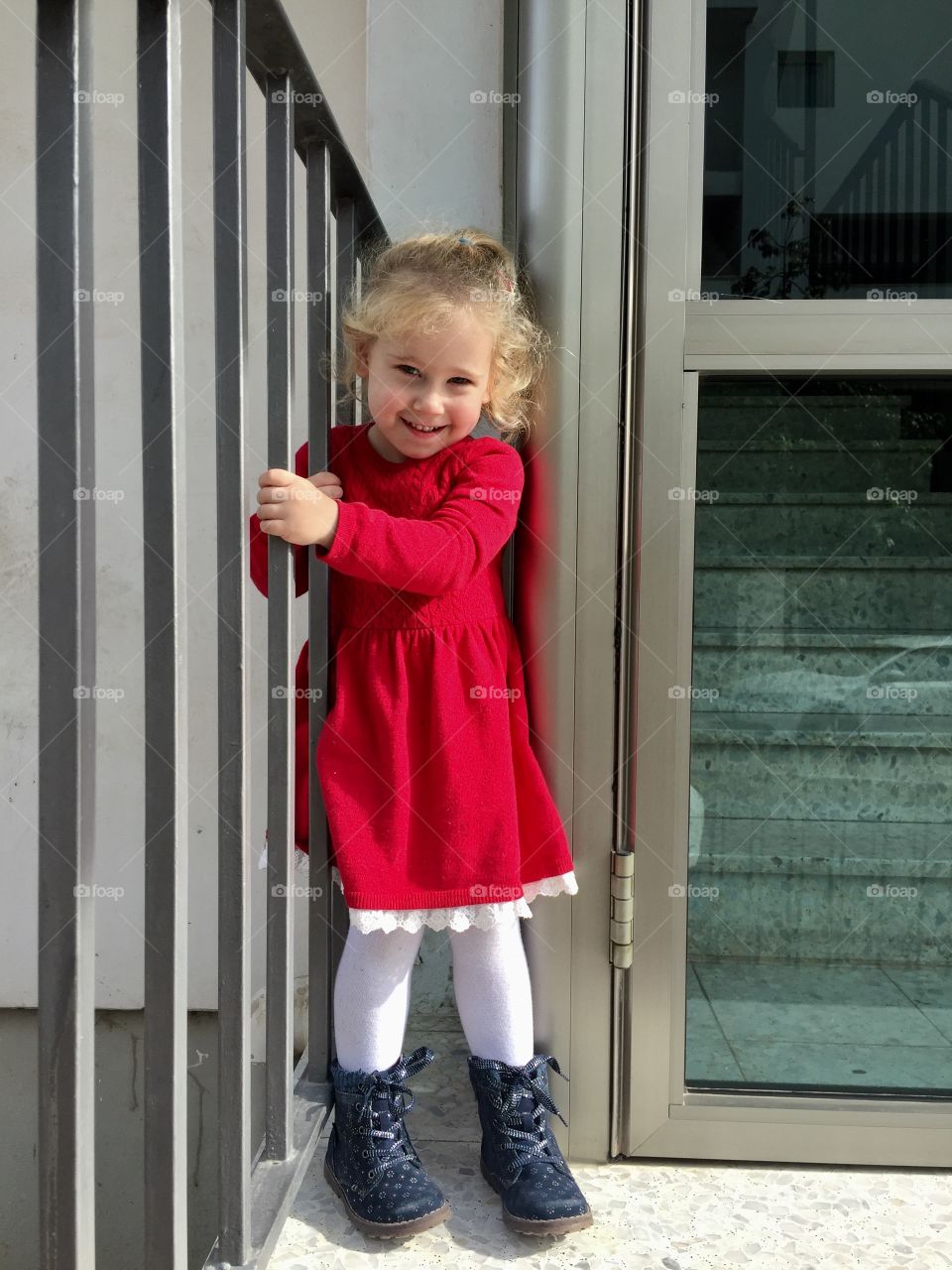 Little girl standing near the railing