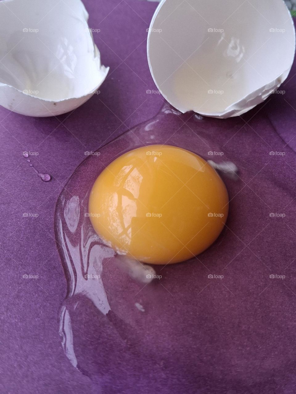 yellow yolk on a purple background, showing the combination of complementary colors