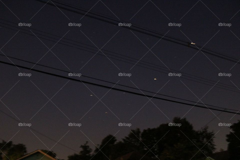 stars in the night sky through telephone wires