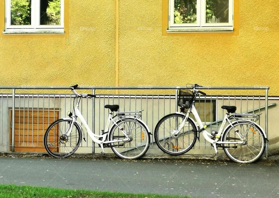 Bicycles in front of yellow house