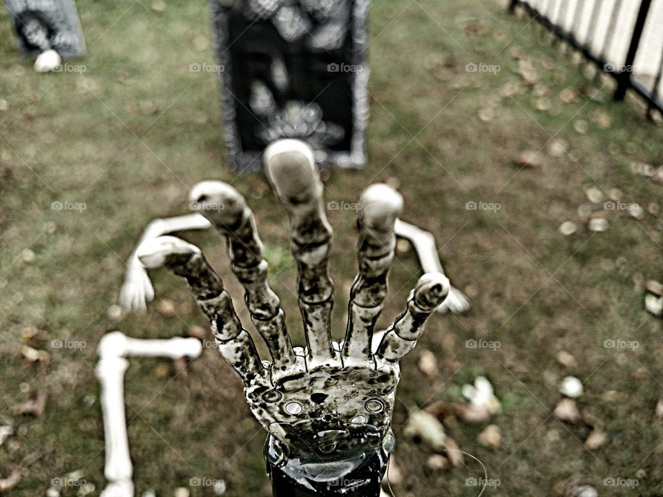 skeletons come to life in this front yard graveyard Halloween decoration