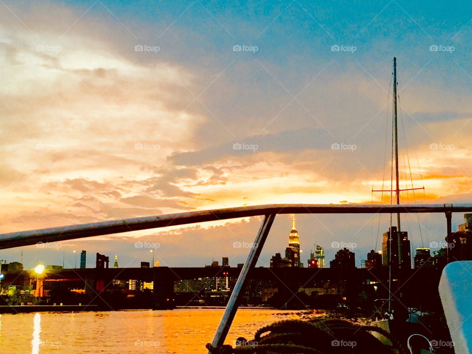 Sunset over Newtown Creek in Long Island City, Queens from aboard our sailboat, the “Salvation” during the “golden hour” in the summer of 2018. In the distance you can see the Empire State Building and the Manhattan skyline. Hypnotic Productions
