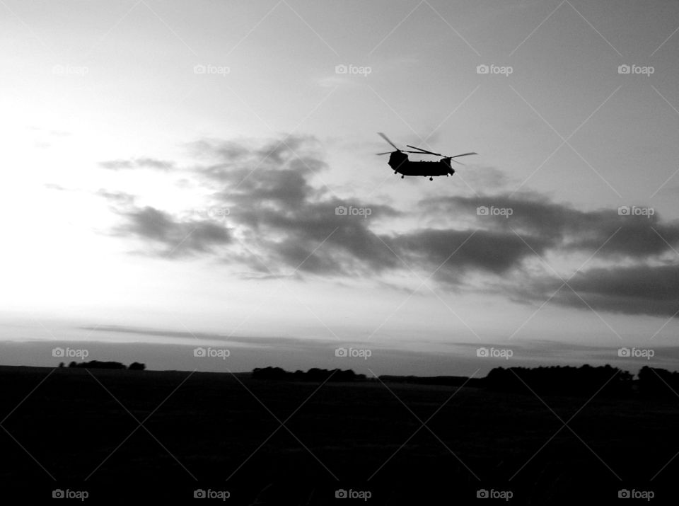 Army helicopter flying over English landscape