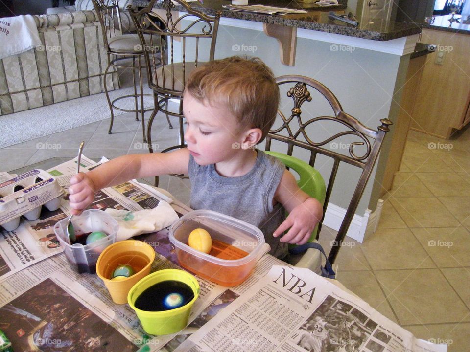 Easter traditions child decorating eggs