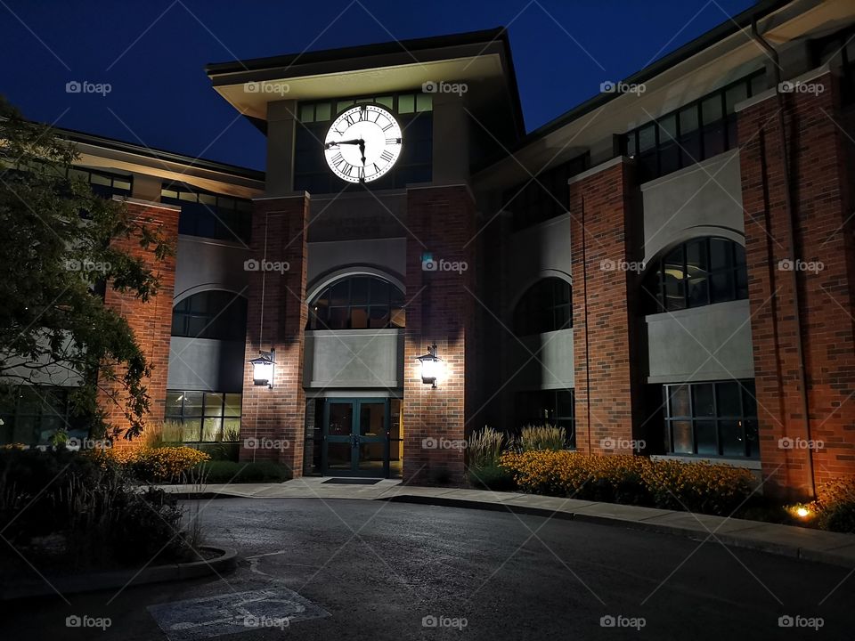 brick building with clock at night