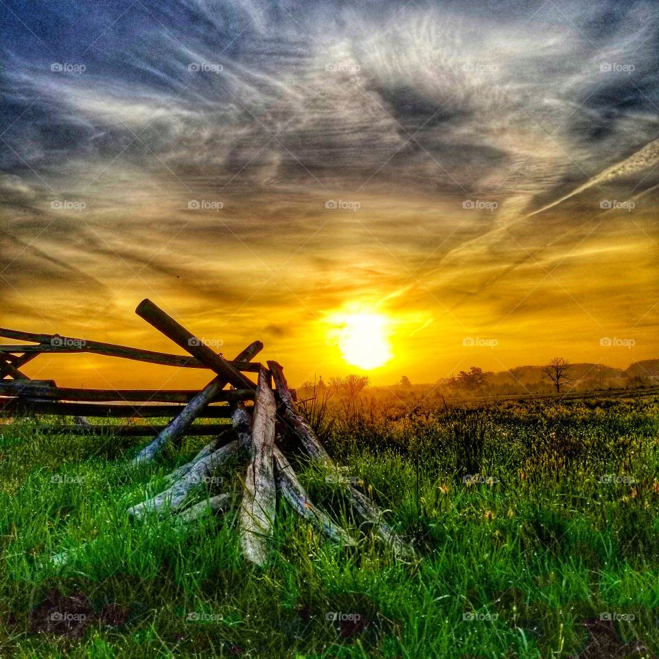 sunrise and split rail fence