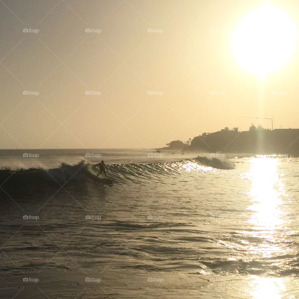 Sunset surfer at Secret Spot in Almadies, Dakar, Senegal