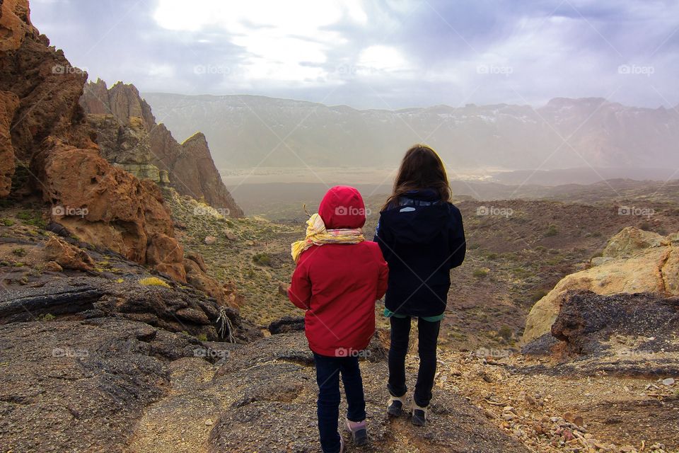 Kids exploring in front of mountain panorama