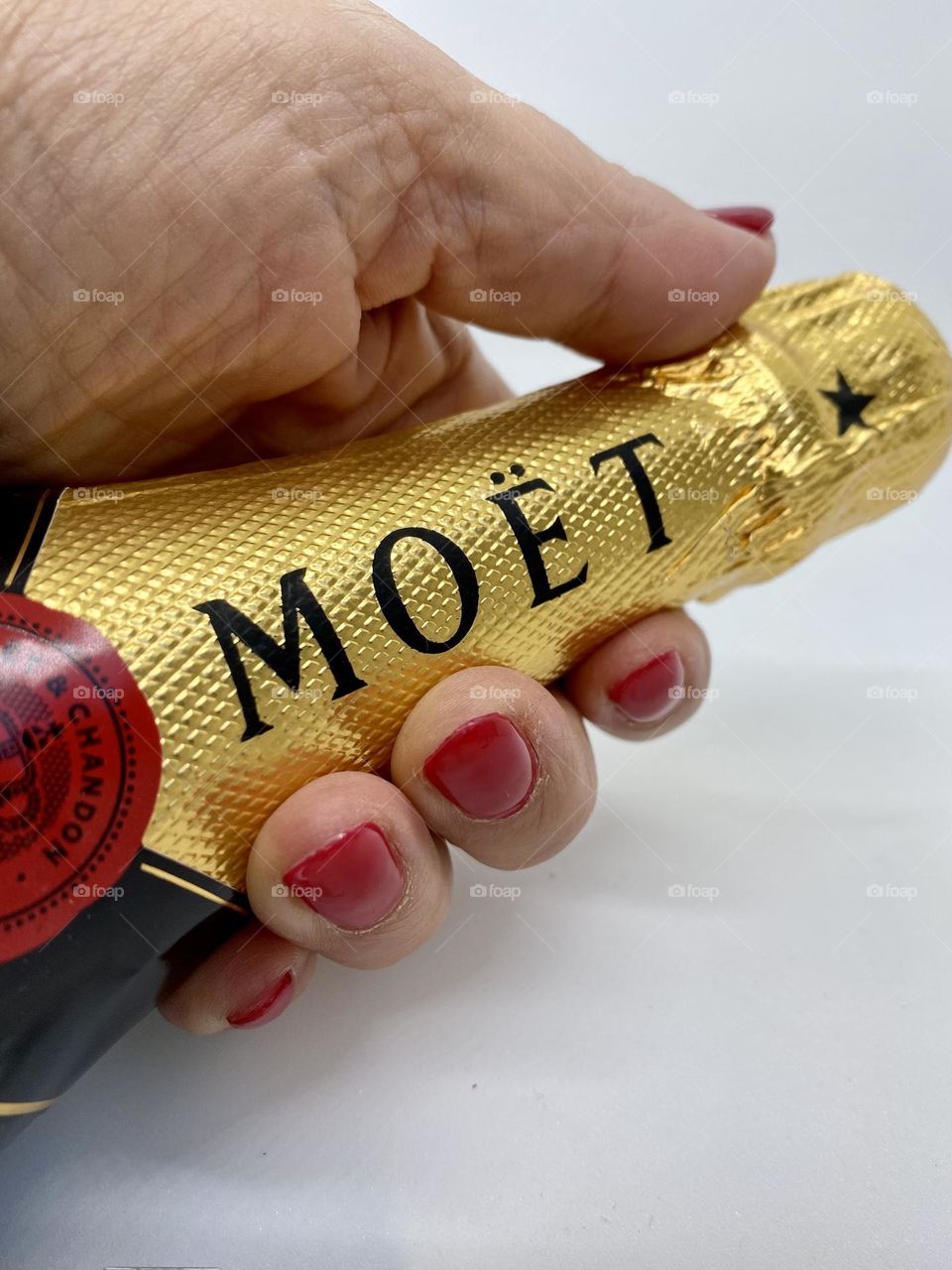 Hand holding bottle of champagne