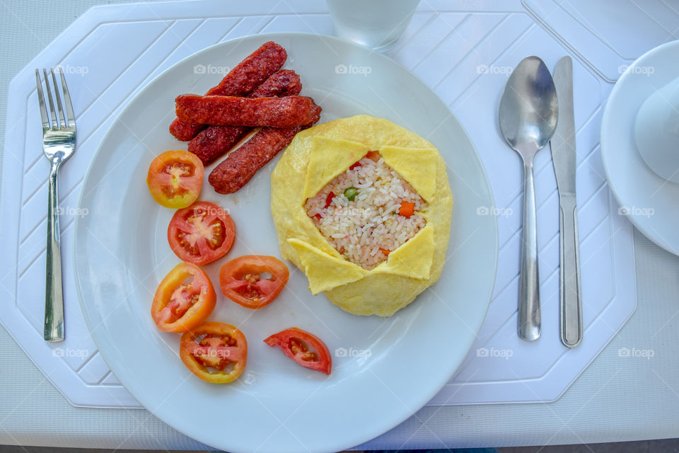 Rice, egg, sausage and tomatoes