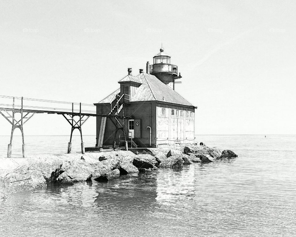 sturgion bay lighthouse in Wisconsin in black and white pencil sketch version calm peaceful water with nice reflection door county