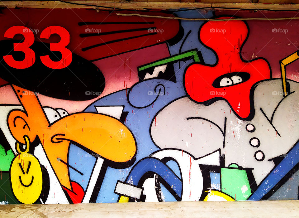 Graffiti.  Humor.  An old woman and a man in a mask