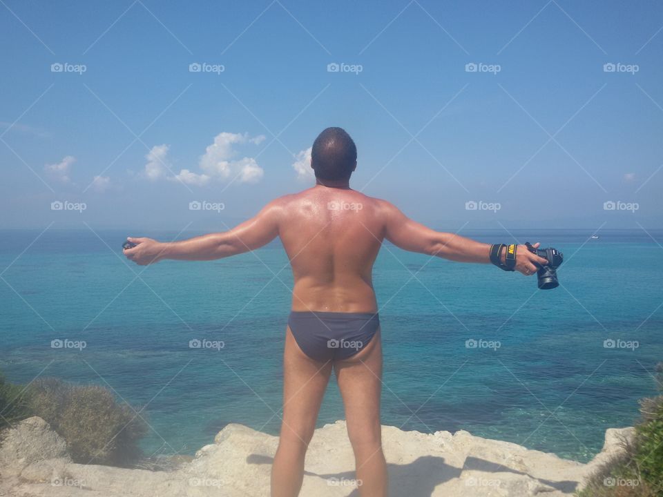 Man with camera on the beach