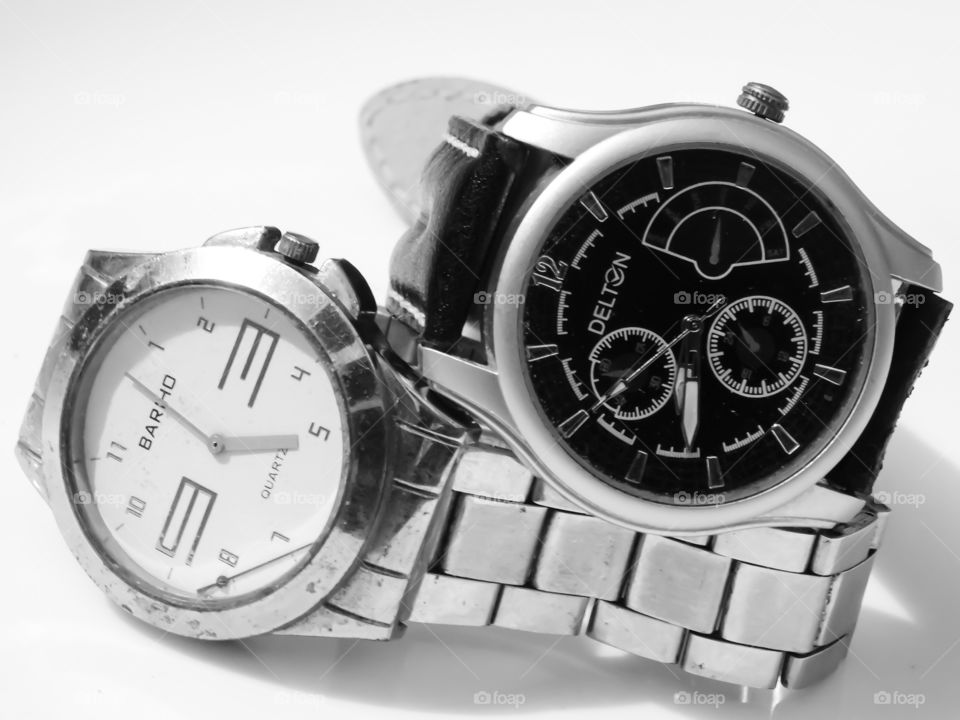 Watch for men - My favorite gadget. Two analog wrist watches arranged with black and white dial and steel belt.