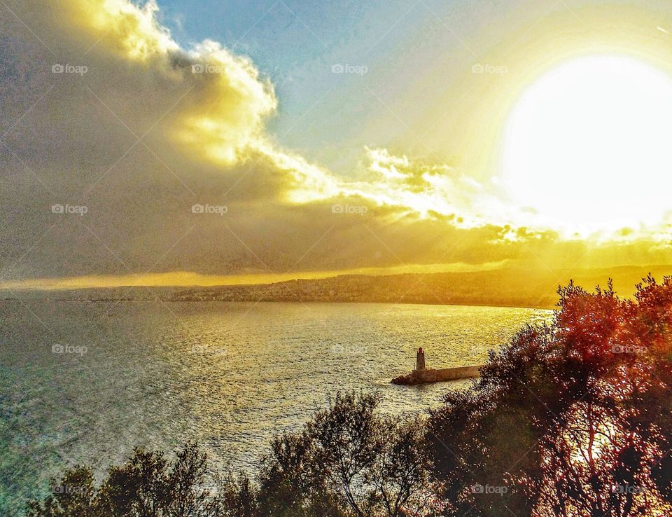 Sunset over Mediterranean and Nice lighthouse “Phare de la Garoupe” 