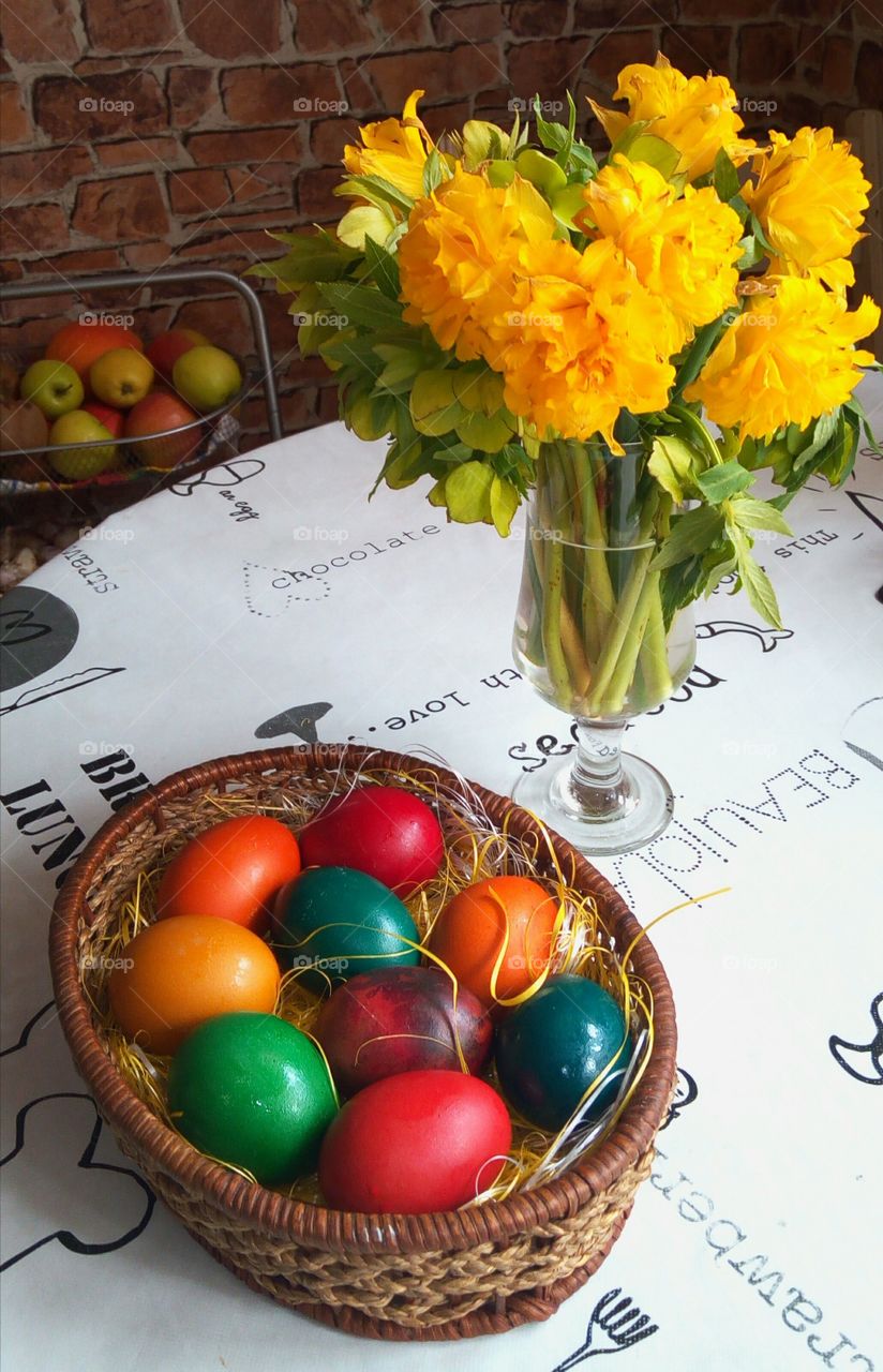 Easter eggs and flowers in glass