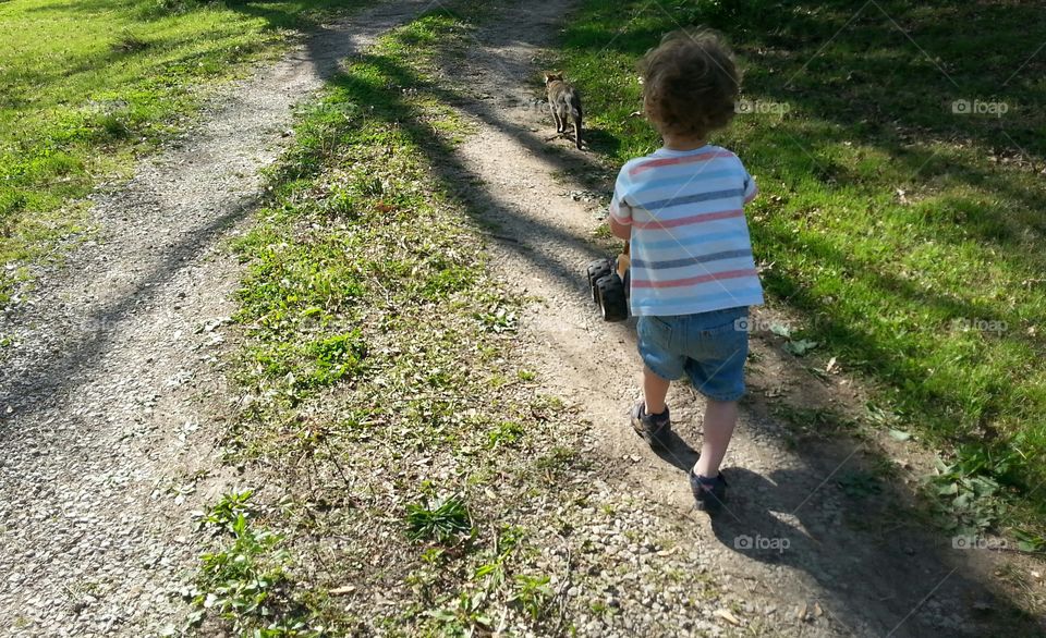 A Boy and His Cat. A boy follows his cat as he plays.