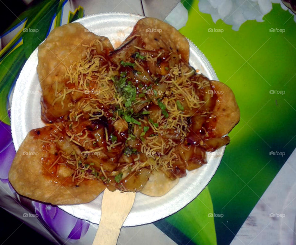 Papdi chaat is one of the popular street snacks of India. Crisp fried discs topped with potatoes.