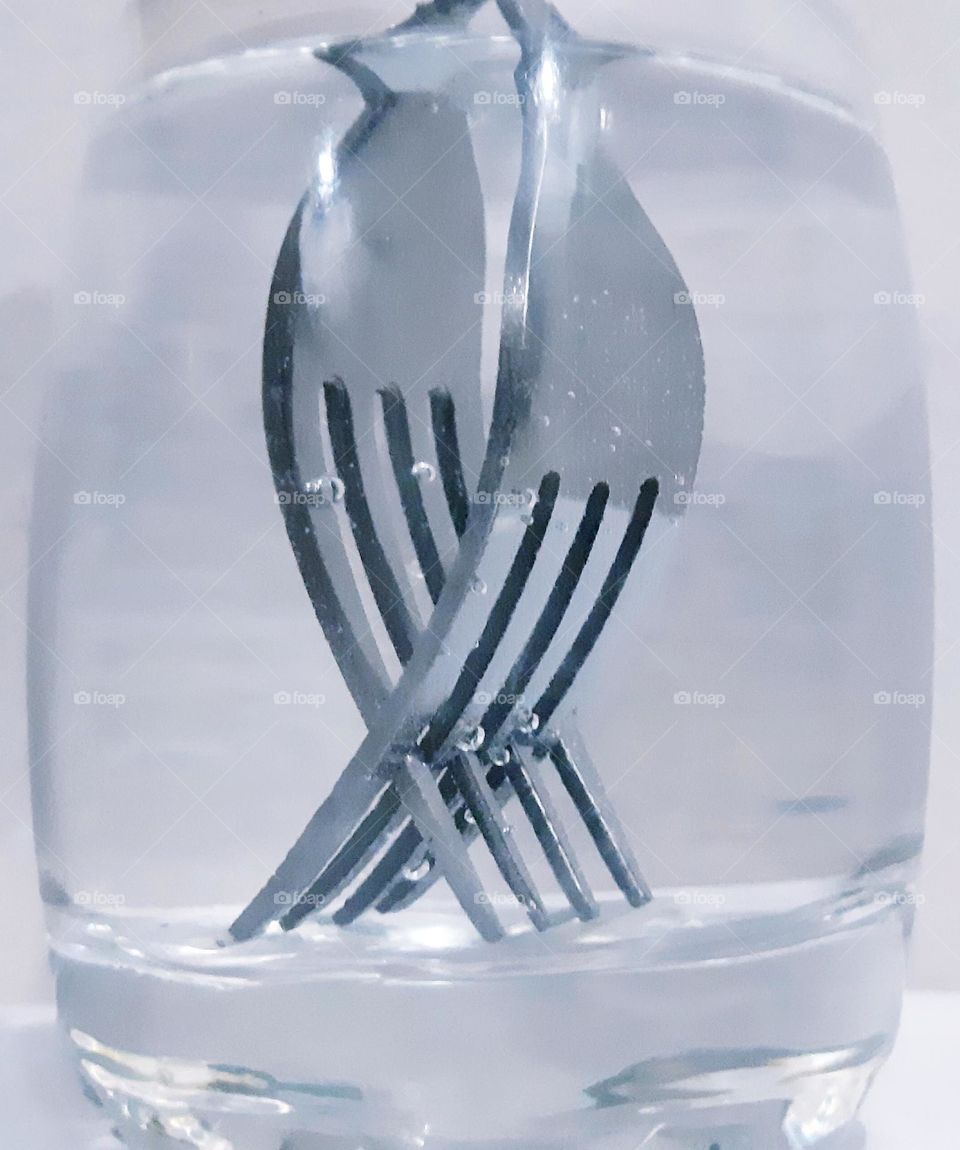 Two forks in the glass of water