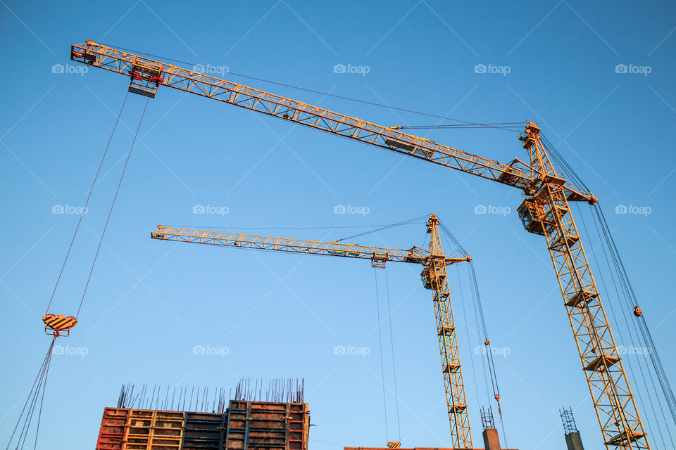 construction cranes on blue sky background