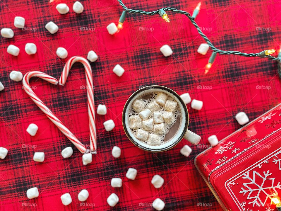 Hot cocoa on a cold winter day, hot chocolate and candy canes, marshmallows and candy canes, red plaid with hot chocolate, winter drink favorites, marshmallows and candy canes with hot chocolate 