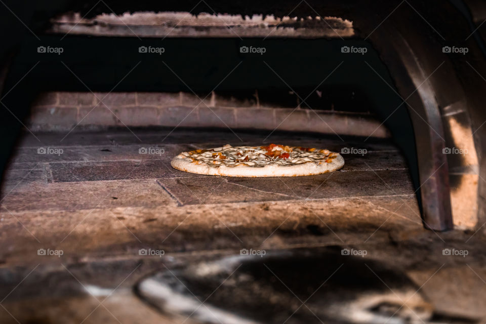 Pizza preparation in wood fired oven