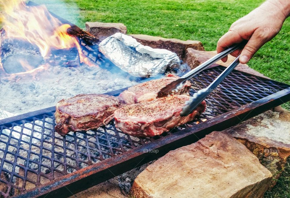 Steaks Cooked Over the Open Fire Pit