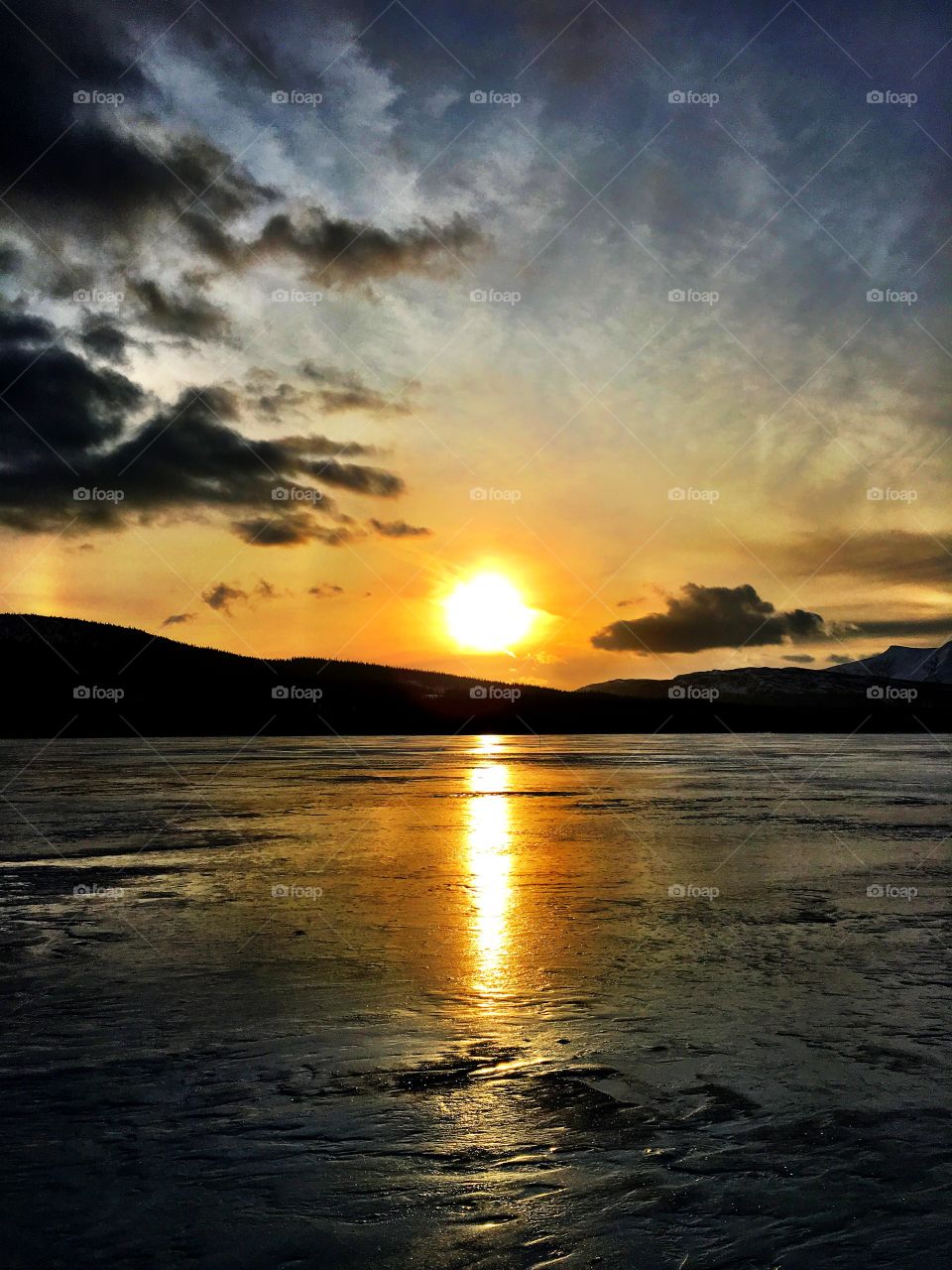 Sunset on icy lake 