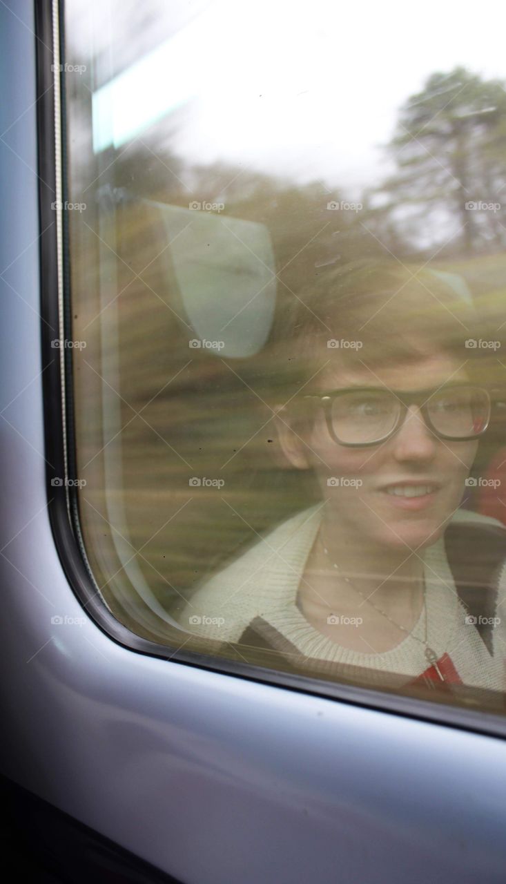 Reflection of a girl in a train window