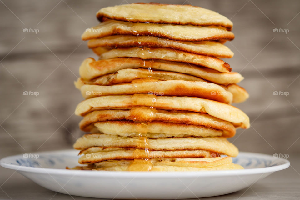 Pile of freshly made golden pancakes on a plate