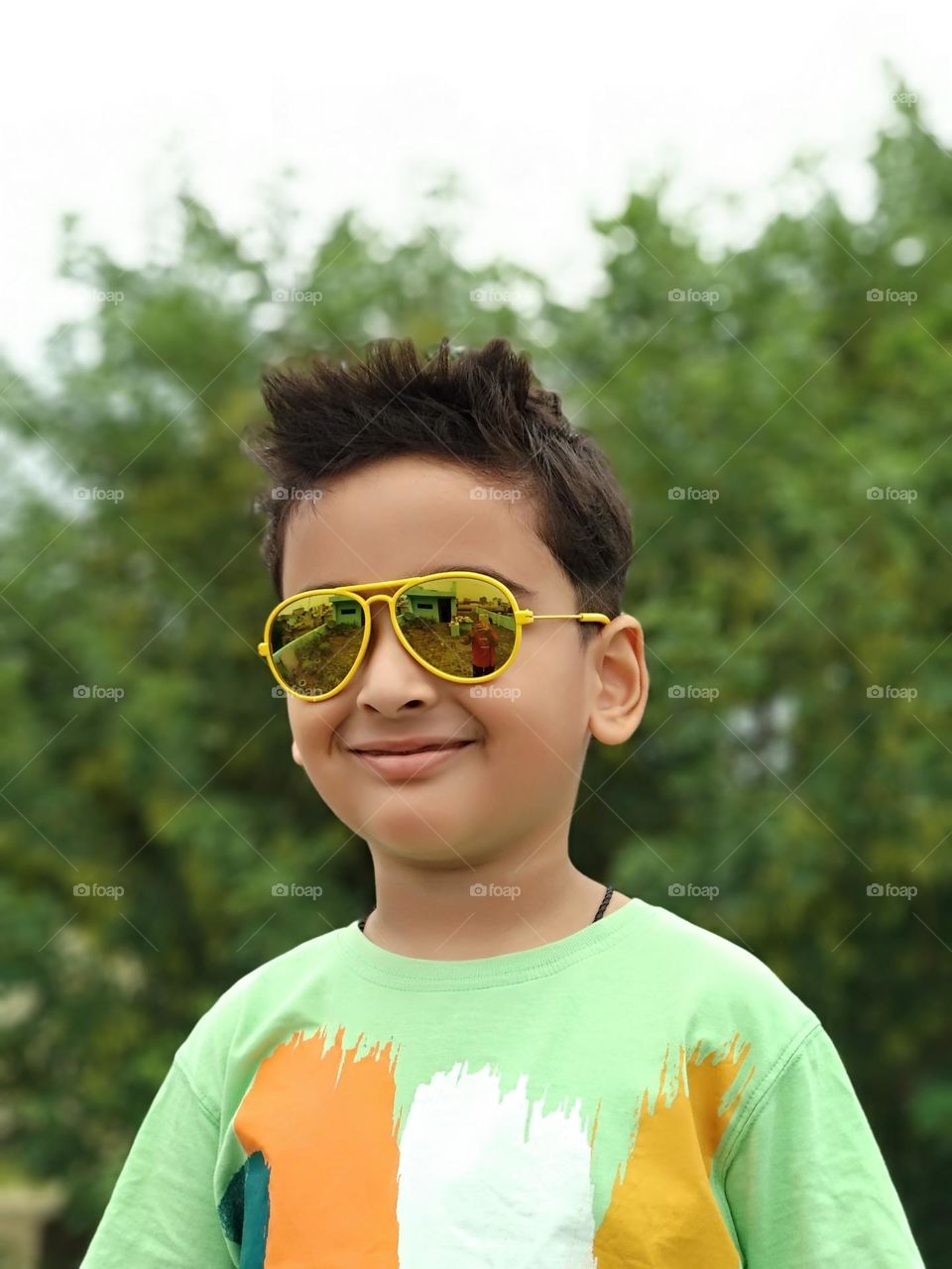 cute smiling Indian boy wearing sunglasses