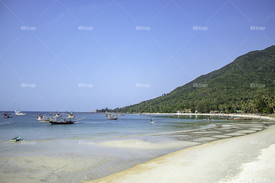 Fishing boats parked on the Beach at Koh Phangan, Surat Thani in Thailand.