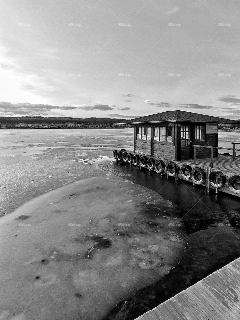 pier on the lake in winter evening