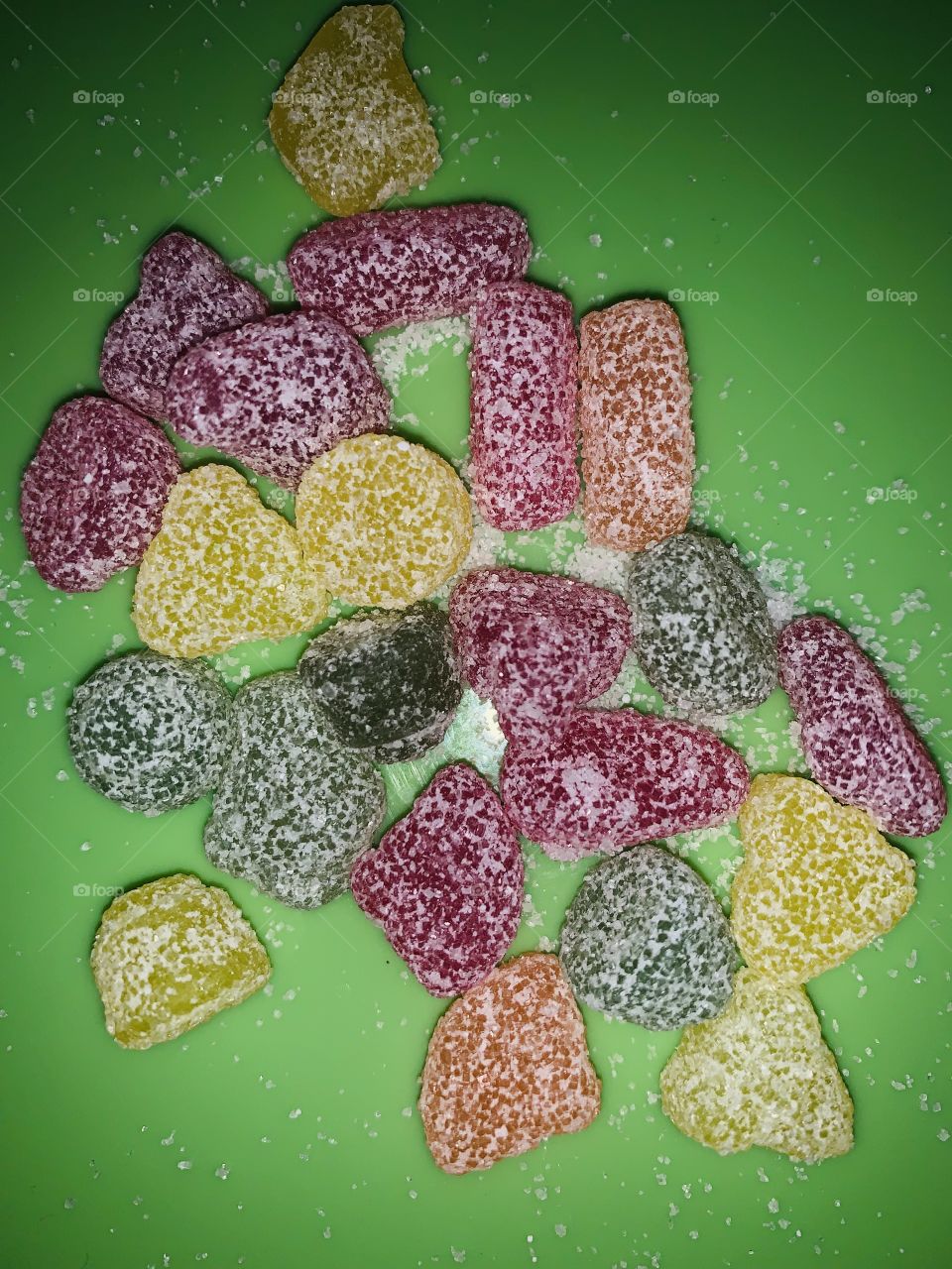 Sour candy on a green background 
