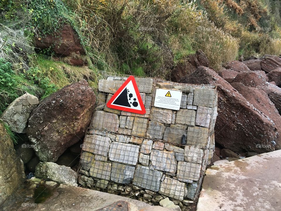 Strange beach accessories, how on earth did this crate of rocks get delivered to  this beach.