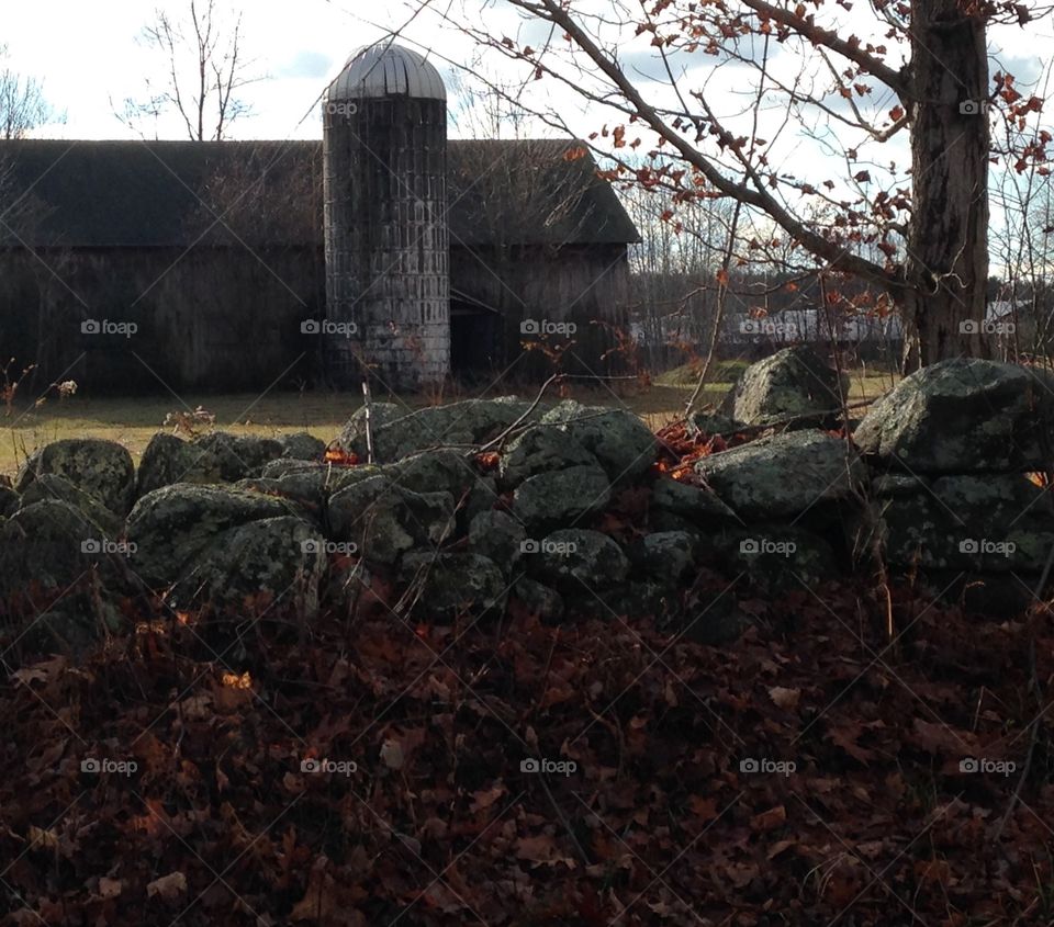 Grey stone wall and barn on my travel home through the country 