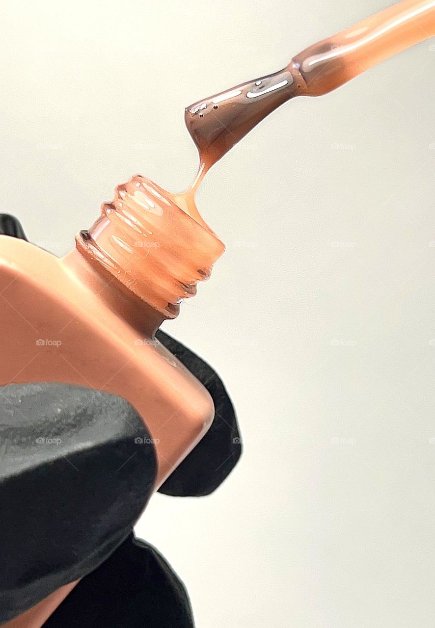 Terracotta nail polish on a light background