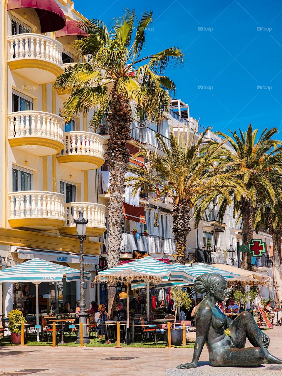 Summer vibes in Sitges, Spain. People sitting in restaurants, enjoying the sun and the breeze.